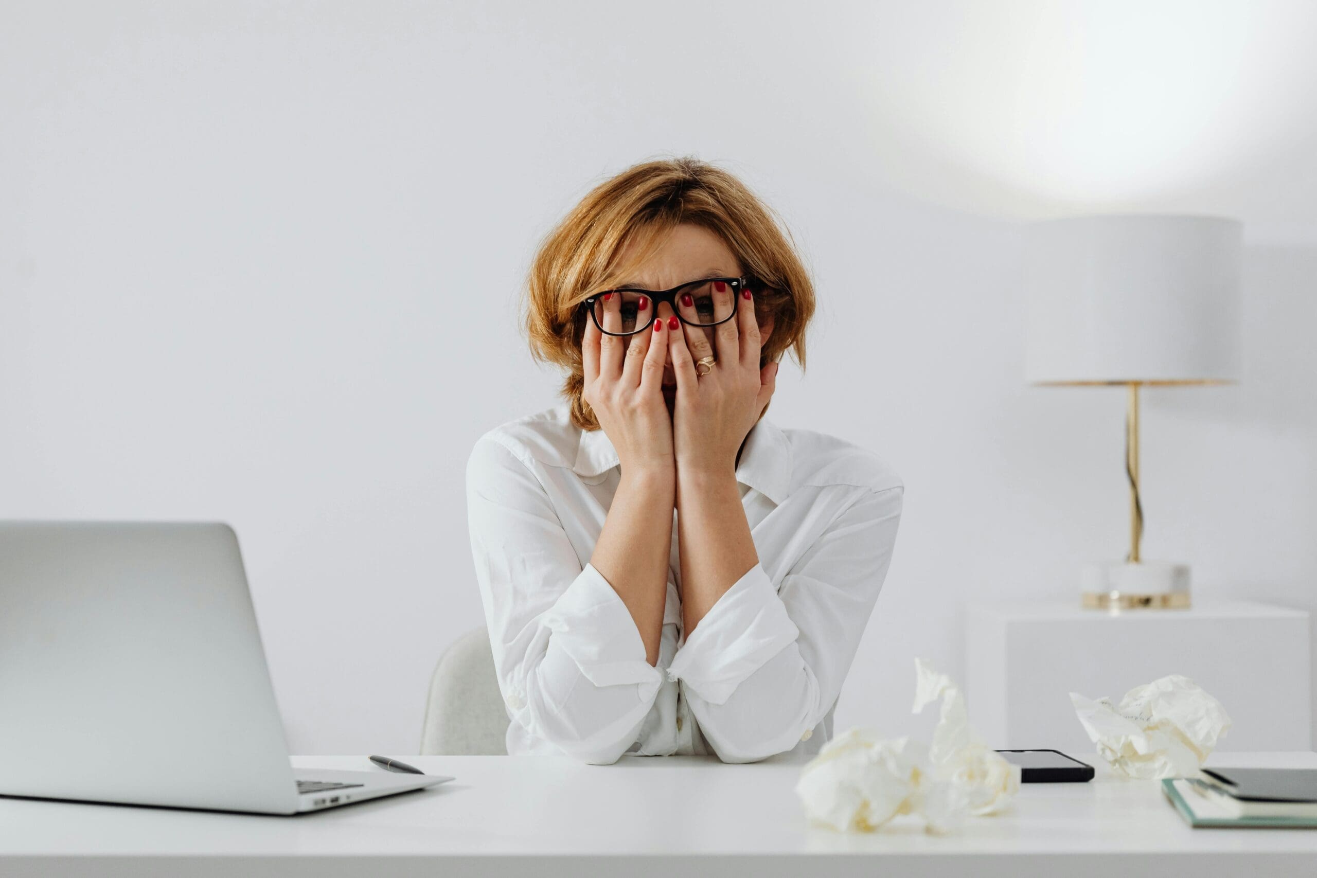 a lady holding her head in her hands.