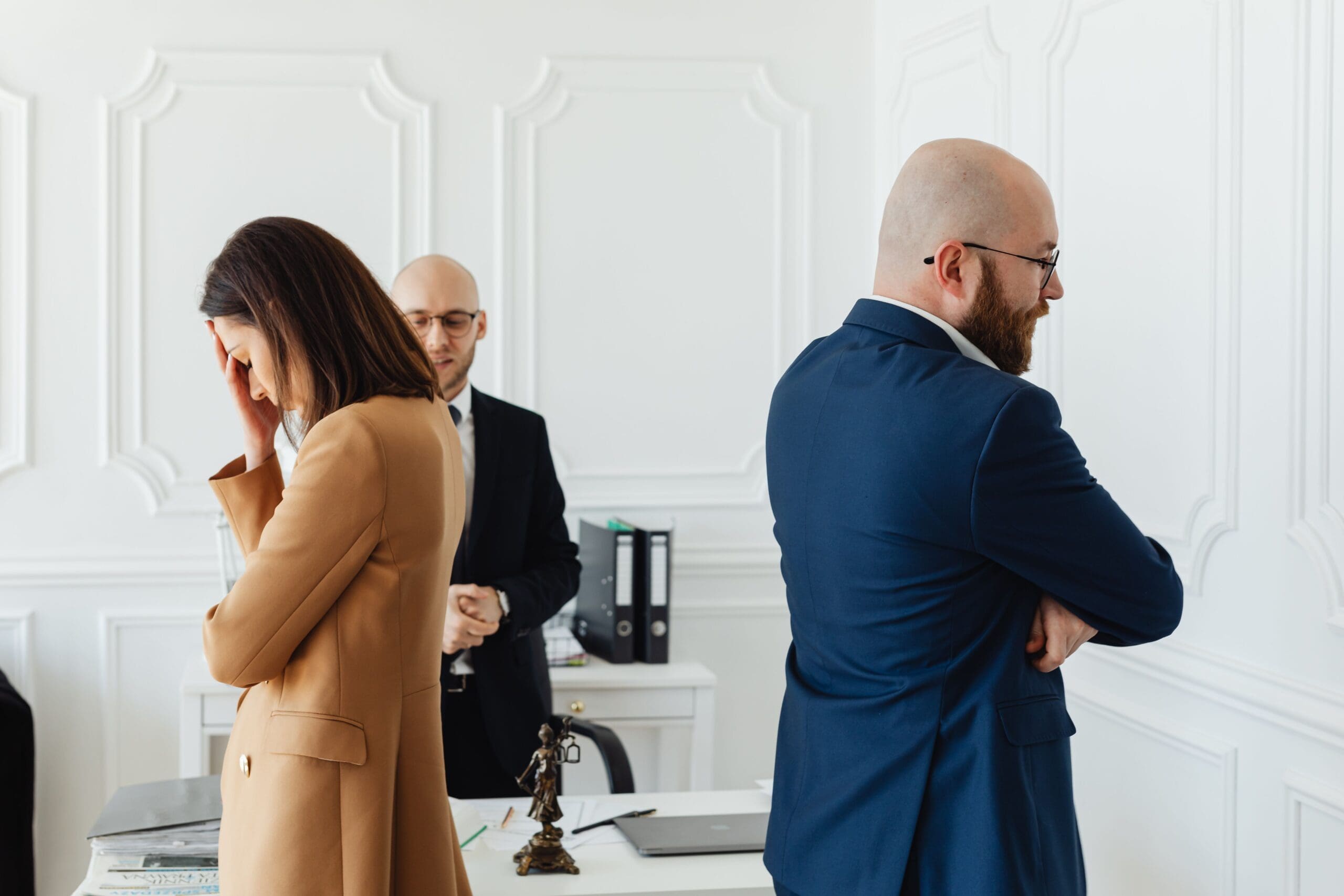 two people looking upset with their backs turned away from each other