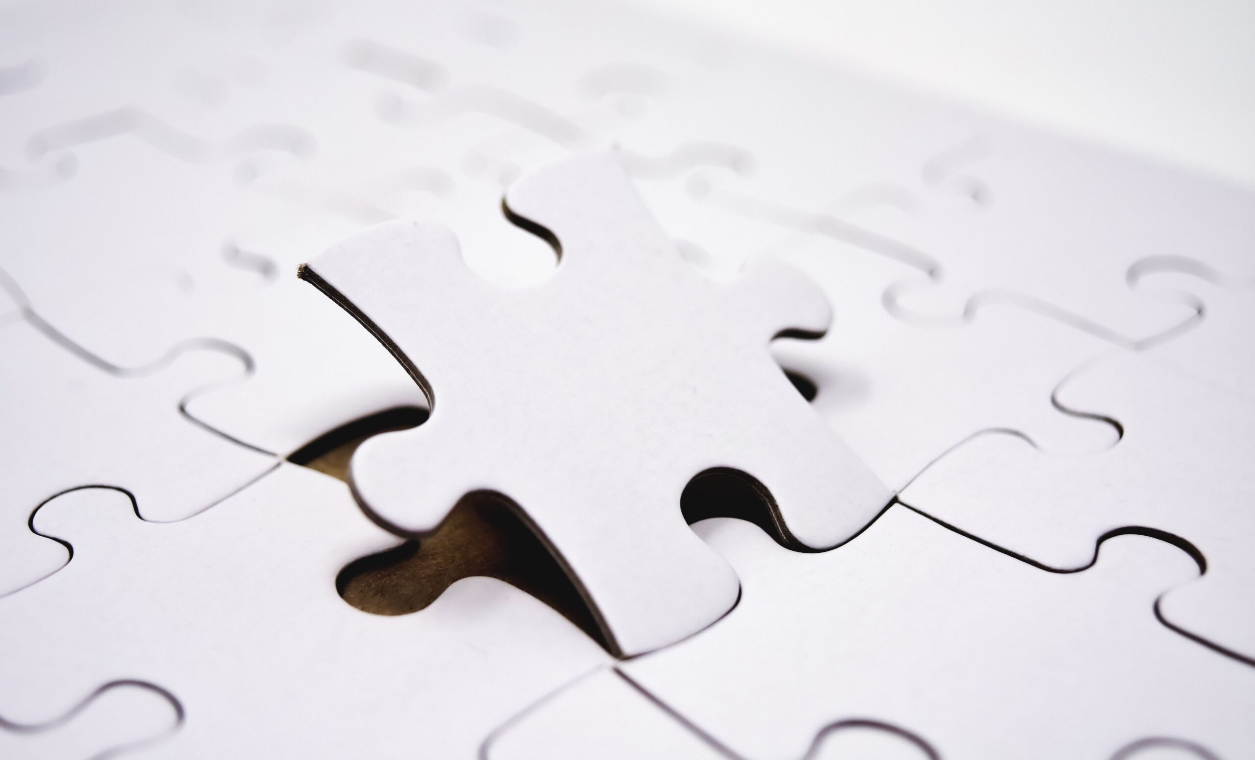 white puzzle with a piece sticking up